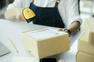 Scanning parcel barcode before shipment photo