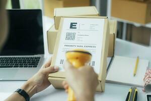 Scanning parcel barcode before shipment. photo