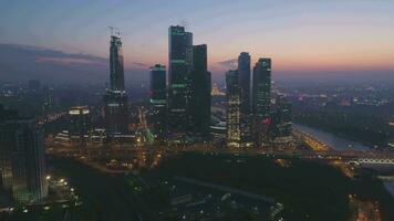 Skyscrapers of Moscow City Business Center and City Skyline in Summer Morning Twilight. Russia. Aerial View. Drone is Flying Forward, Camera is Tilting Up video