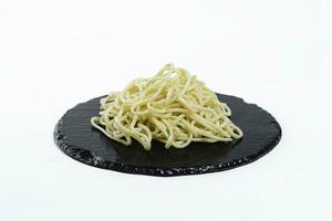 delicious egg noodles on a black plate.Garnish. View from above. Chinese cuisine, hotpot ingredient photo