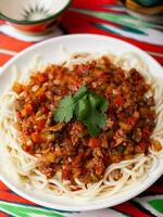 The oriental dish guiru lagman is homemade noodles fried with meat, vegetables and herbs. Eastern cuisine photo