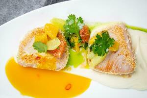 fish with tangerines, parsley and sesame breaded side view photo