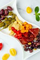 assorted nuts and dried vegetables on a light background top view photo