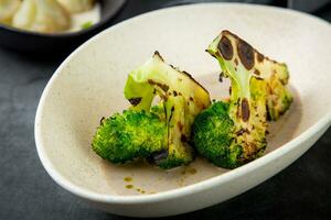 cooked broccoli in mushroom sauce and lime photo