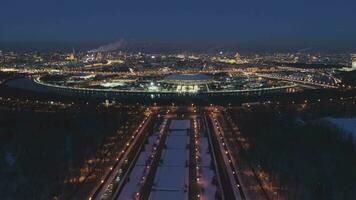 Luzhniki Stadium and Illuminated Moscow Skyline at Frosty Winter Evening. Russia. Aerial View. Drone is Flying Forward and Upward. Establishing Shot video