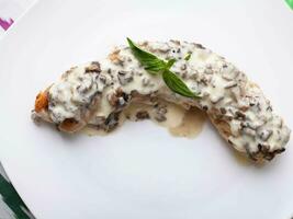 Salmon steak with creamy sauce and mushrooms with herbs. Asian style photo