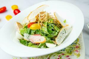 salad with quail eggs, cherry tomatoes, lettuce and breadcrumbs, side view photo