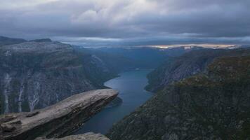 trolltunga Cliff im Norwegen. berühmt Troll Zunge Felsen im beim Sonnenuntergang im Sommer. Zeit Ablauf. Zoomen im video