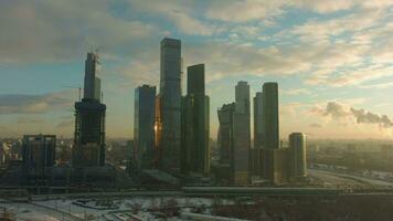 Skyscrapers of Moscow City Business Center and Urban Cityscape in Sunny Winter Morning. Russia. Drone is Orbiting and Flying Upwards. Establishing Shot video