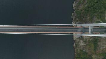 Hardanger Suspension Bridge across the Hardangerfjord with Passing Car in Norway. Aerial Vertical Top-Down View. Drone is Flying Sideways video