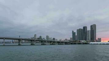 Miami centre ville Urbain ligne d'horizon, macarthur chaussée et baie à le coucher du soleil. journée à nuit temps laps, uni États de Amérique video