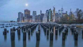 Cityscape of Lower Manhattan and River with Piers in the Morning. New York City, United States of America. Night to Day Time Lapse video