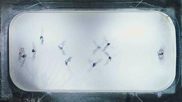 Players on Ice Rink Playing Hockey. Aerial Vertical Top-Down View. Static Drone Shot video