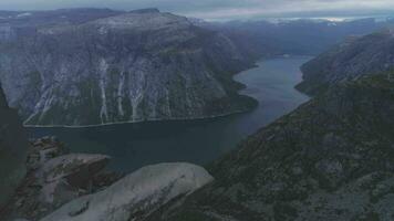 trolltunga Cliff im Norwegen. berühmt Troll Zunge Felsen im Sommer- Tag. Antenne verraten Schuss. Drohne ist fliegend nach vorne, Kamera ist kippen oben video