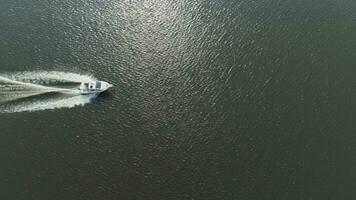 Luxury Speed Motor Boat in the Sea at Sunny Day. Aerial Vertical Top-Down View. Drone is Flying Sideways to the Right video