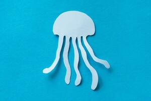 jelly fish paper cut isolated on blue photo