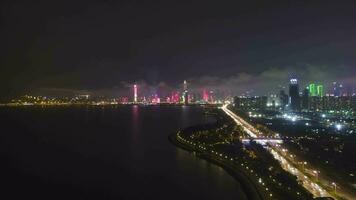 SHENZHEN, CHINA - MARCH 29, 2019 Nanshan District and Shenzhen Bay at Night. Aerial Hyper Lapse, Time Lapse. Drone Flies Forward, Tilt Up. Guangdong video