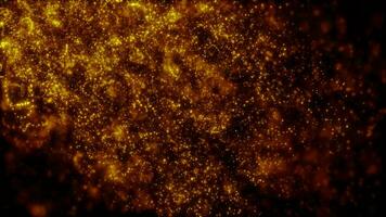 Blurred yellow abstract background of bokeh and small round particles of energy magical holiday flying dots on a black background video