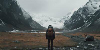 Generative AI, backpacker in winter landscape, traveler man tourist with backpack hiking in mountains photo