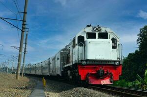 The train is running on the rails towards the destination photo