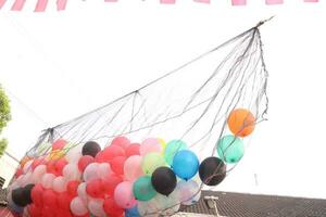 Collection of tied balloons with clouds photo