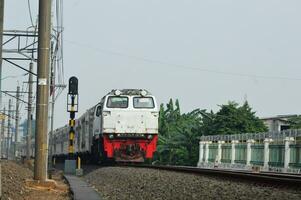 The train is running on the rails towards the destination photo