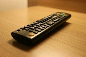 Close up of the television remote on the table photo