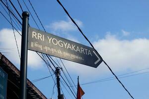 Direction sign in Jogjakarta with clouds photo