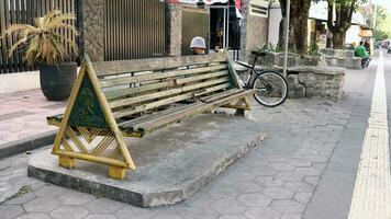 Bench on the side of the street in Jogjakarta photo