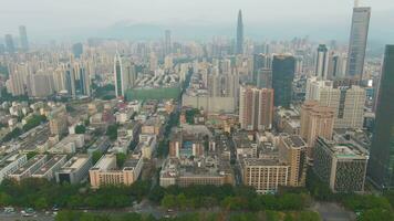 Shenzhen City at Day. Luohu and Futian District Skyline. China. Aerial View. Drone Flies Forward, Camera Tilts Up, Reveal Shot video