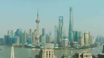 Shanghai City. Huangpu and Lujiazui Cityscape at Clear Day. China. Aerial View. Drone Flies Backwards and Downwards. Medium Shot video