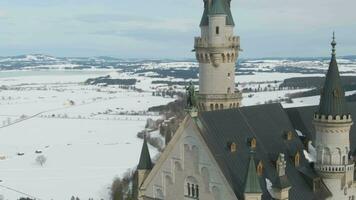 Neuschwanstein Castle in Winter Day and Statue. Mountains and Snow Field. Bavarian Alps, Germany. Aerial View. Medium Shot. Drone is Orbiting Clockwise video