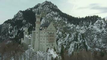 Neuschwanstein Castle in Winter Day. Mountains and Forest. Bavarian Alps, Germany. Aerial View. Wide Shot. Drone is Orbiting Counterclockwise, Flies Upwards video