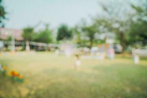 Defocused bokeh and blur background of garden trees in sunlight with vintage toned. photo