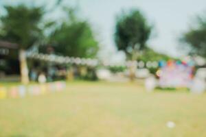 Defocused bokeh and blur background of garden trees in sunlight with vintage toned. photo