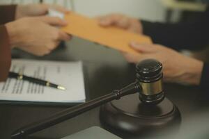 Business and lawyers discussing contract papers with brass scale on desk in office. Law, legal services, advice, justice and law concept picture with film grain effect photo