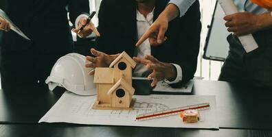 Construction and structure concept of Engineer or architect meeting for project working with partner and engineering tools on model building and blueprint in working site, contract for both companies. photo