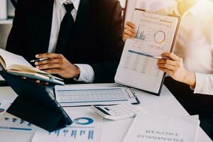 businessman working on desk office with using a calculator to calculate the numbers, finance accounting concept photo