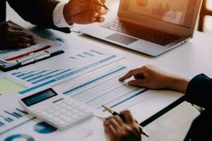 businessman working on desk office with using a calculator to calculate the numbers, finance accounting concept photo
