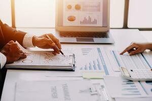 businessman working on desk office with using a calculator to calculate the numbers, finance accounting concept photo