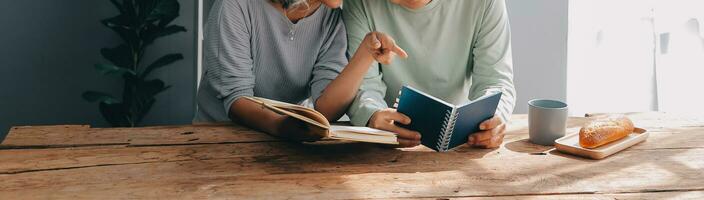 Embraced mature couple surfing the Internet on laptop at home photo