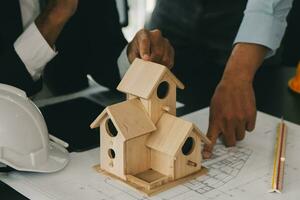 Construction and structure concept of Engineer or architect meeting for project working with partner and engineering tools on model building and blueprint in working site, contract for both companies. photo