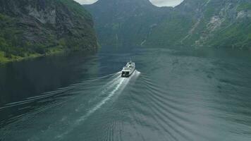 Ferry in Geiranger Fjord in Summer Day. Green Mounains. Norway. Aerial View. Reveal Shot. Drone is Flying Forward, Camera is Tilting Up video