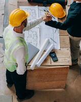 Diverse Team of Specialists Use Tablet Computer on Construction Site. Real Estate Building Project with Civil Engineer, Architect, Business Investor and General Worker Discussing Plan Details. photo