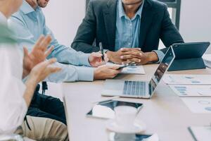 Entrepreneurs and business people conference in modern meeting room, happy multiracial coworkers have fun cooperating working together at office meeting, asian teamwork concept photo