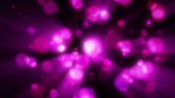 Abstract purple blurred holiday background with magical bokeh of glowing bright light energy small particles of flying dots on a black background video