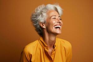 Senior woman laughing heartily isolated on a burnt sienna gradient background photo
