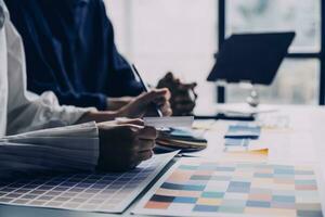 Close up ux developer and ui designer brainstorming about mobile app interface wireframe design on table with customer breif and color code at modern office.Creative digital development agency photo