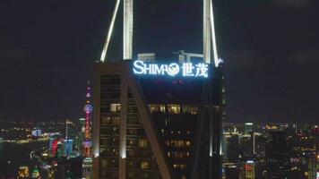 Shimao International Plaza and Lujiazui Skyline at Night. Shanghai City, China. Aerial View. Drone Flies Upwards, Tilt Down. video