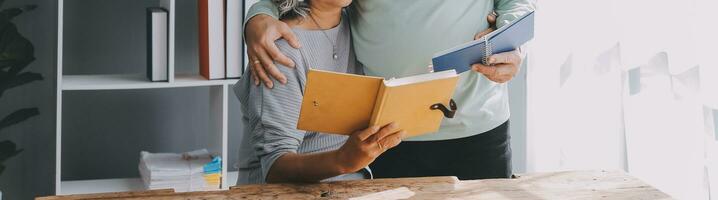 Happy mature couple using laptop at home photo